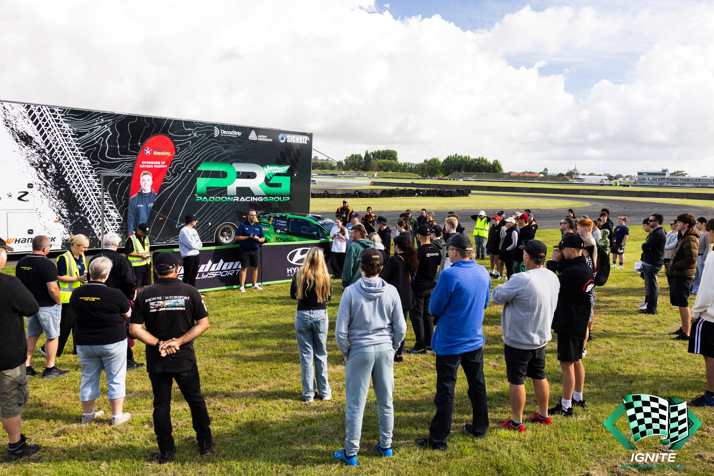 Drivers and families at the Ignite Manawatu briefing beside the PRG truck